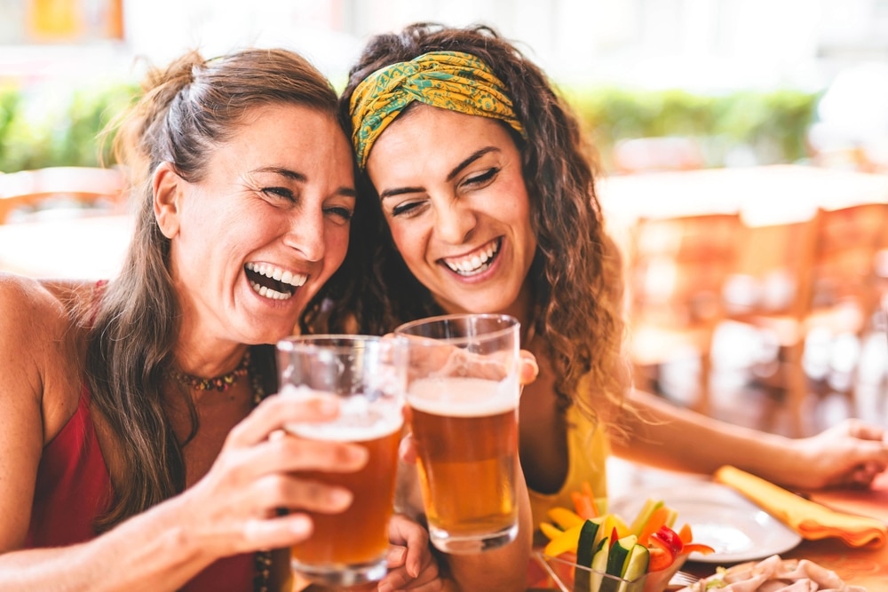 Two happy women drinking beer at Lost Coast Brwery after hiking Humboldt Redwoods State Park.